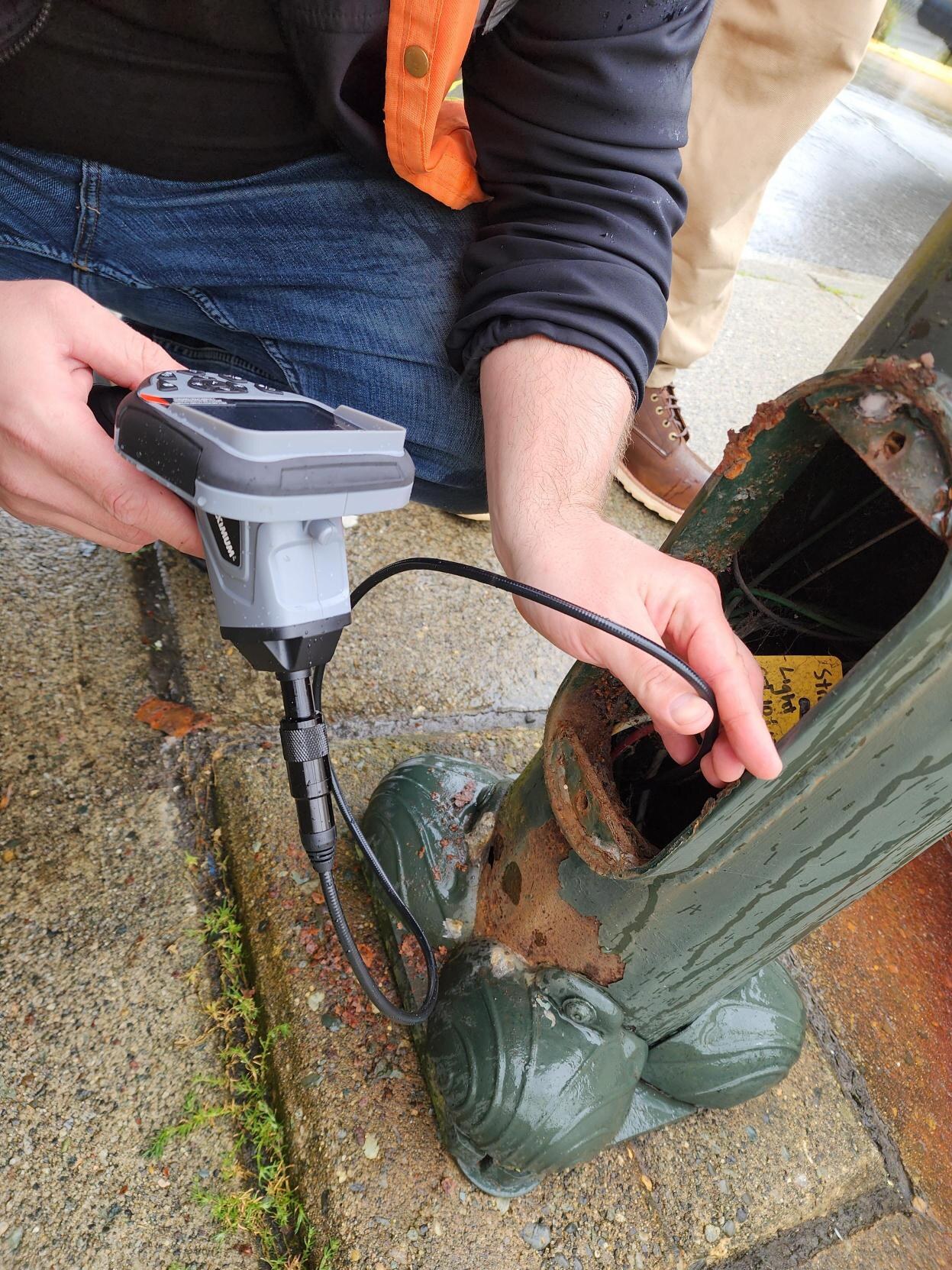 Streetlight pole review for defects, access, and safety.