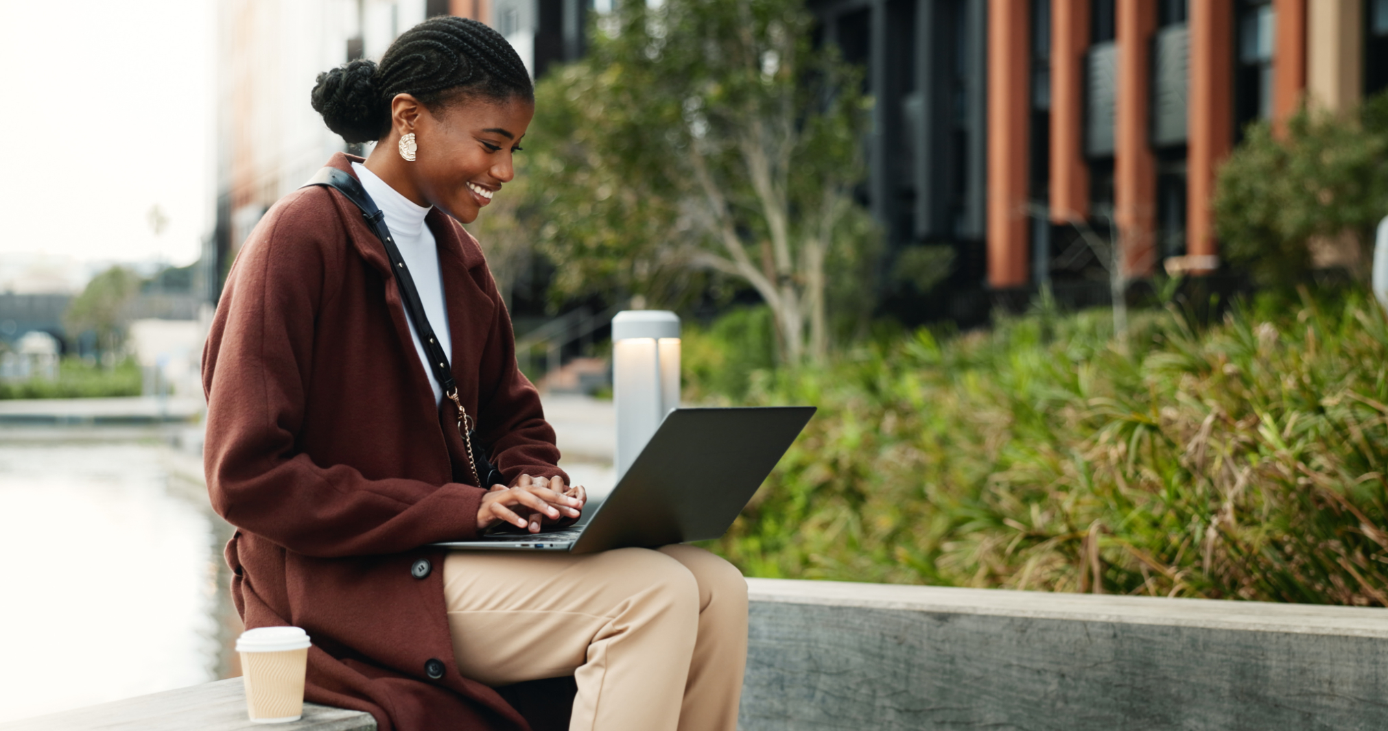 Woman on computer outdoors stock image