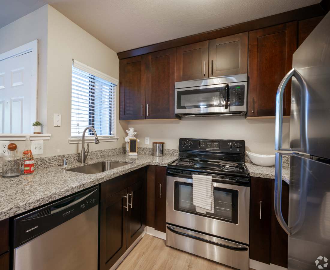Kitchen with brown cabinets and stainless steel appliaces
