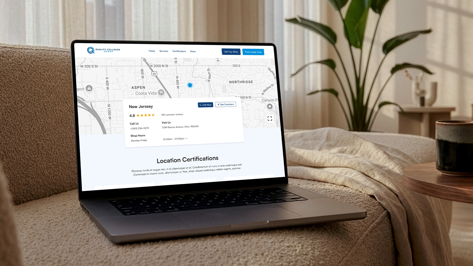 Laptop showing a Quality Collision Group partner website with a location map