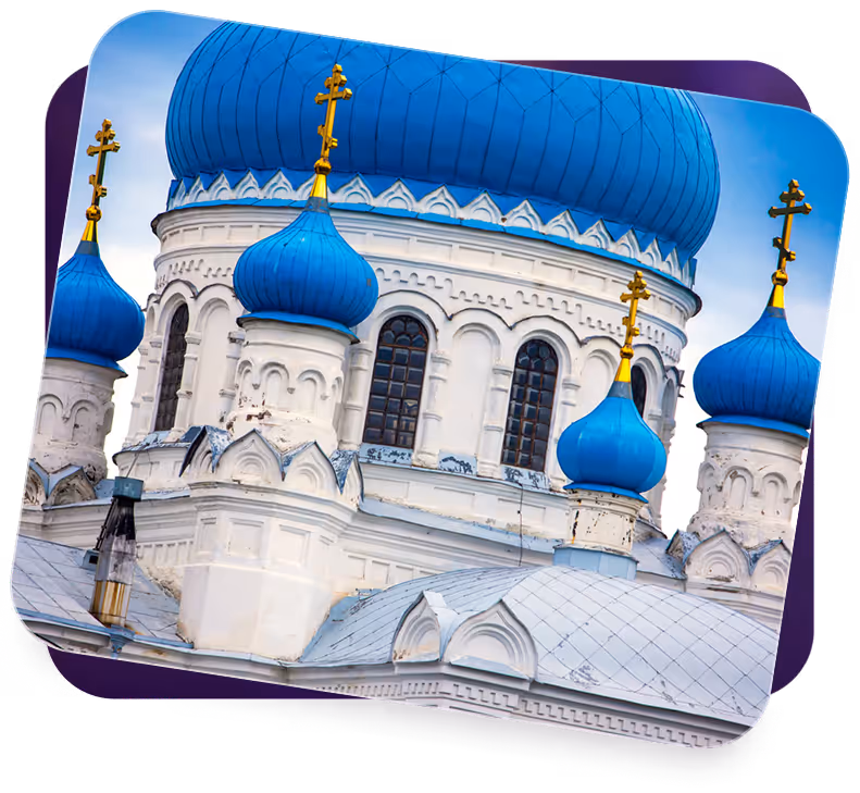 Close-up of Orthodox church domes with blue onion-shaped roofs topped by golden crosses.