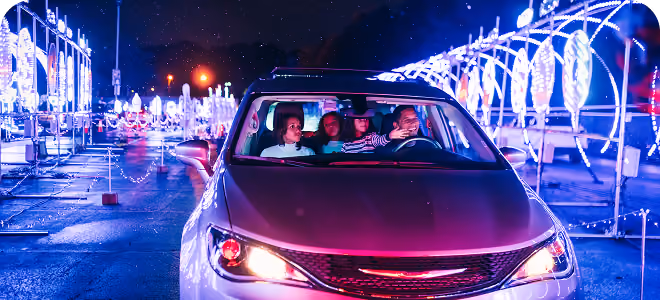 Family driving through a tunnel of white and blue lights
