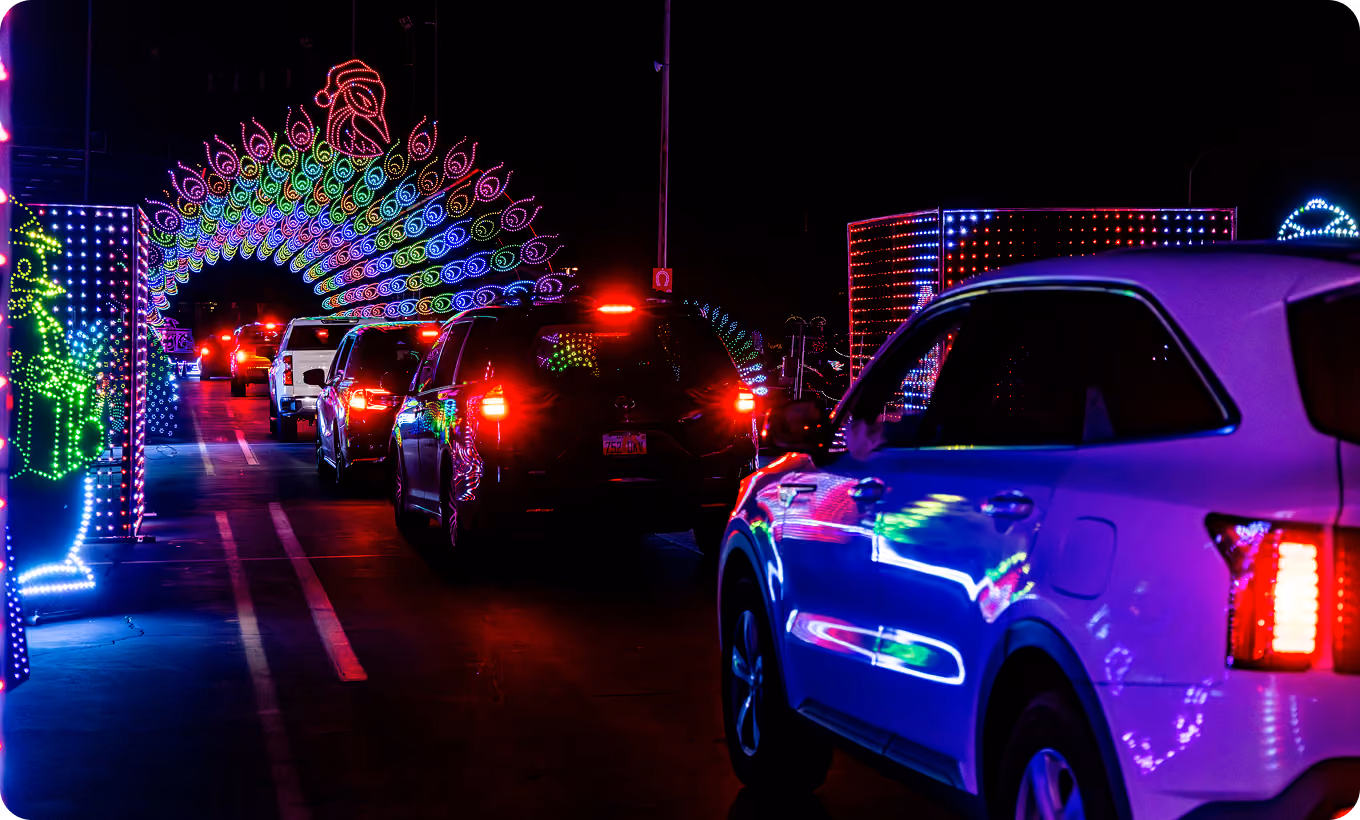 Cars queuing under a rainbow light arch
