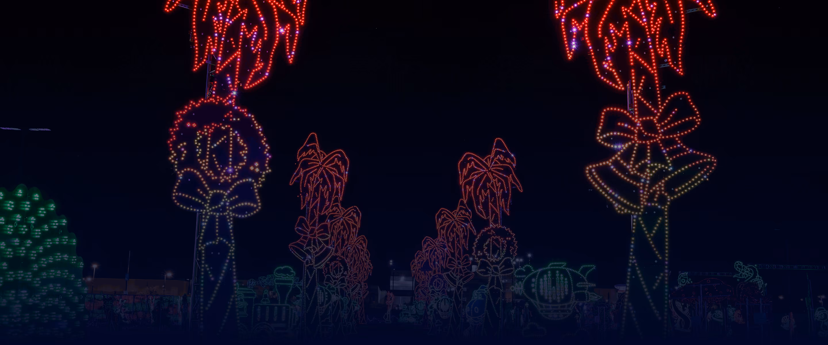 Glowing red reindeer displays lining the drive-through route