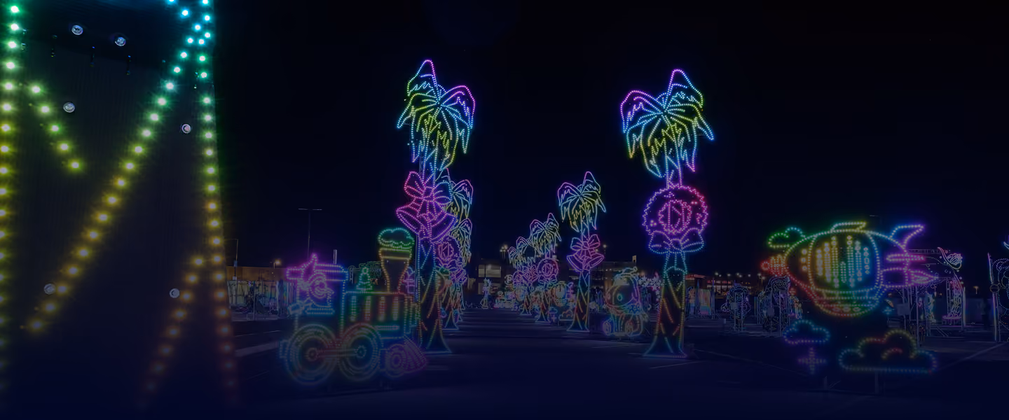 Illuminated palm trees and marquee lights along the route