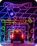 Car driving through a giant neon gift box display