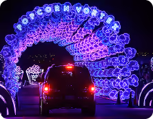 Car driving under the Popcorn Vortex light arch