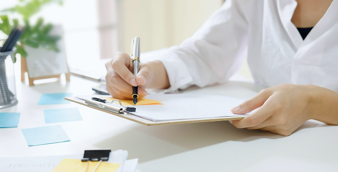 medical admin professional filling out paperwork