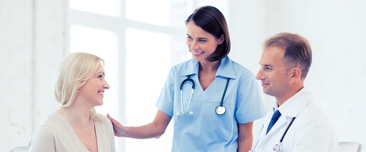 Surgeon and nurse comforting reluctant patient