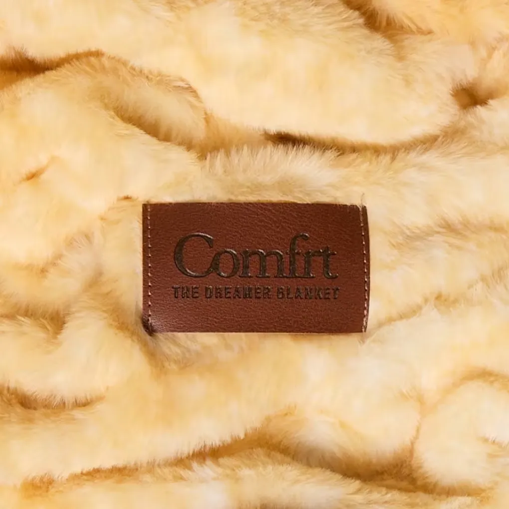 Close-up of the Dreamer Blanket’s plush texture with the Comfrt leather label
