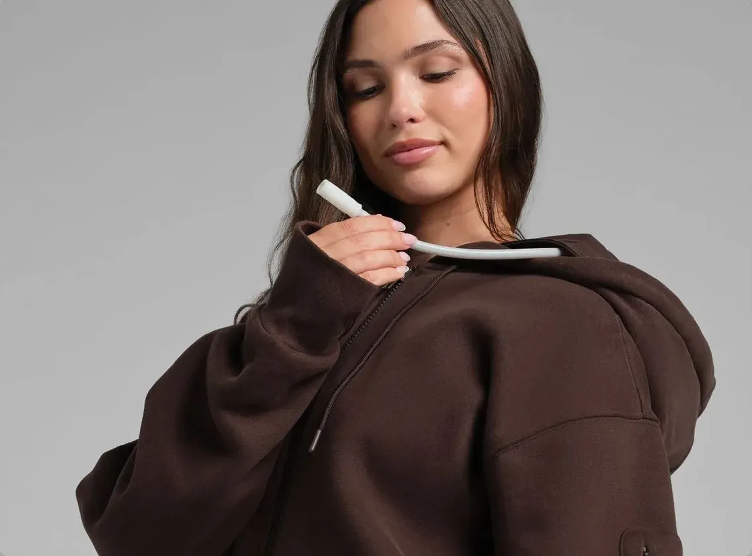 Inflating the neck cushion in the Espresso Inflate Zip Hoodie