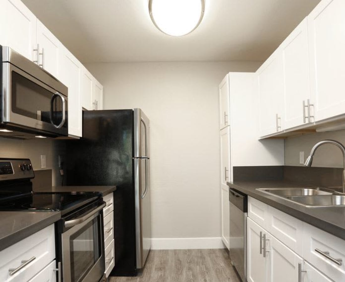 Kitchen with white cabinets and stainless steel appliances