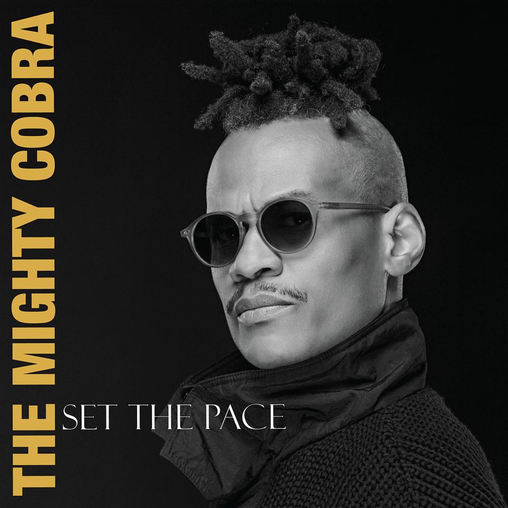 Cover art for the ‘Set the Pace’ EP: a black-and-white portrait of The Mighty Cobra in sunglasses, artist name running down the left edge in yellow.