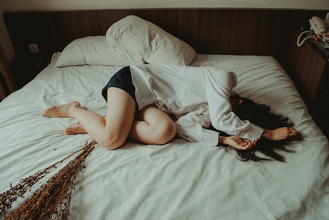 A woman with hormonal imbalance lying on the bed