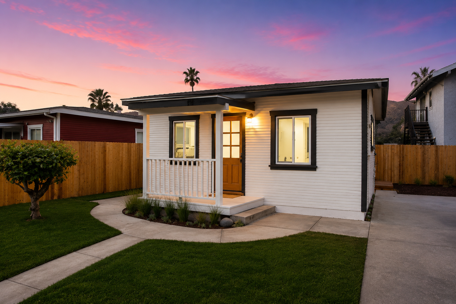 Single-story home renovation with covered front porch at dusk, Orange County