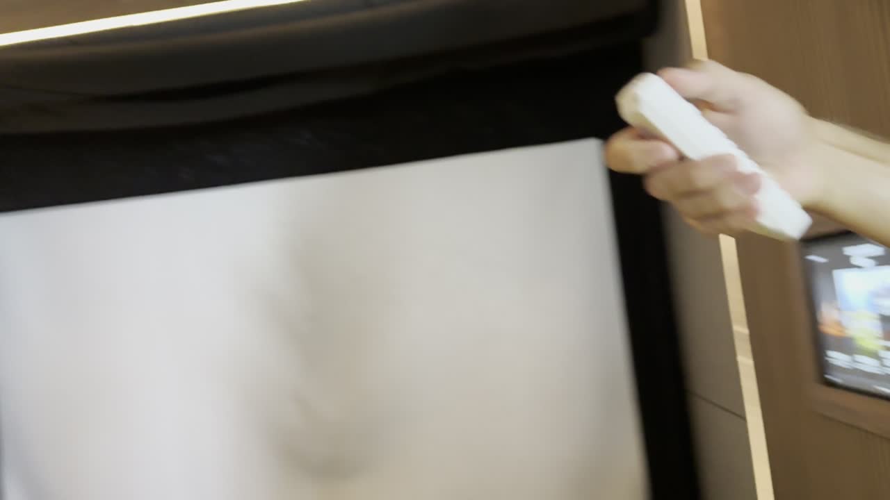 Pointing the projector remote up at the projector
