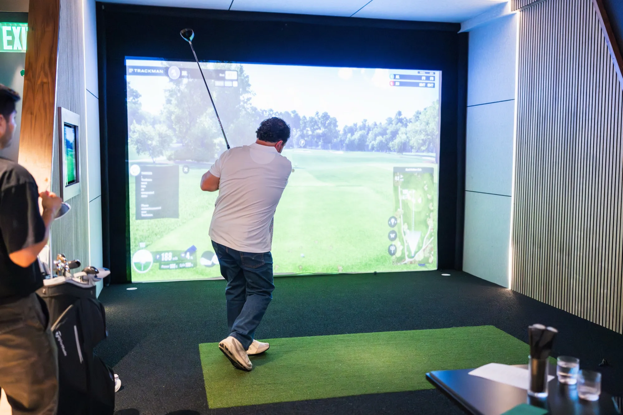 Golfer mid-swing in a bay