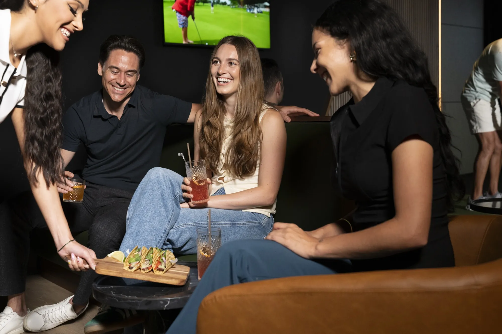 Friends with drinks and food in a bay lounge