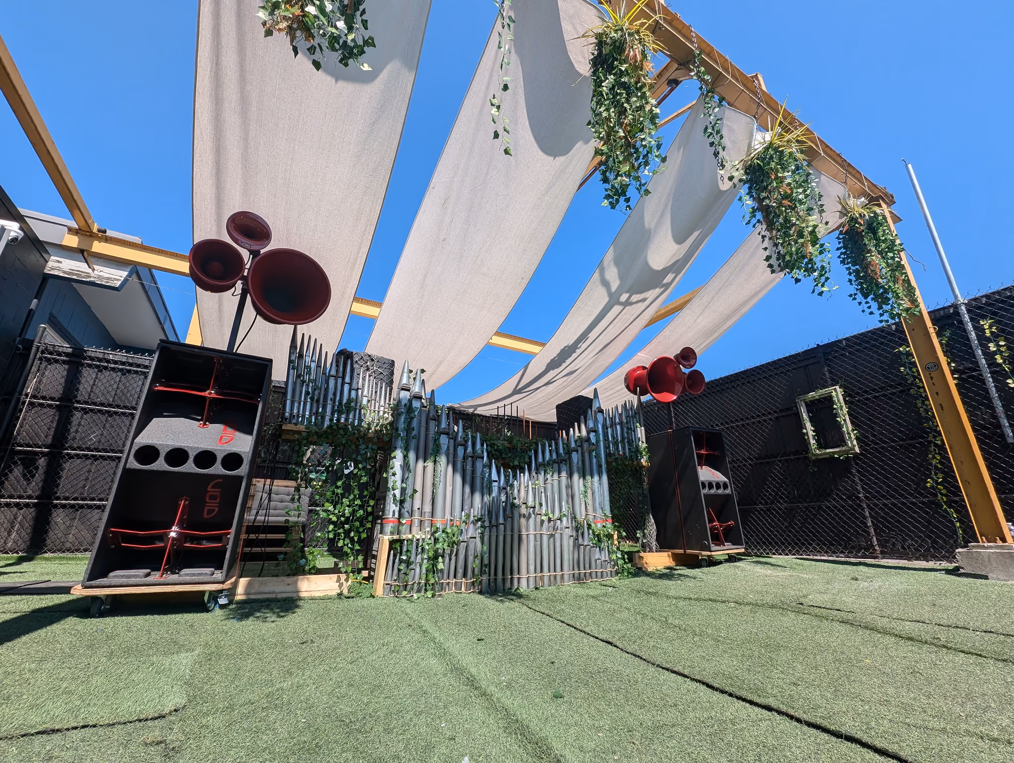 Red horns, foliage and an outdoor stage