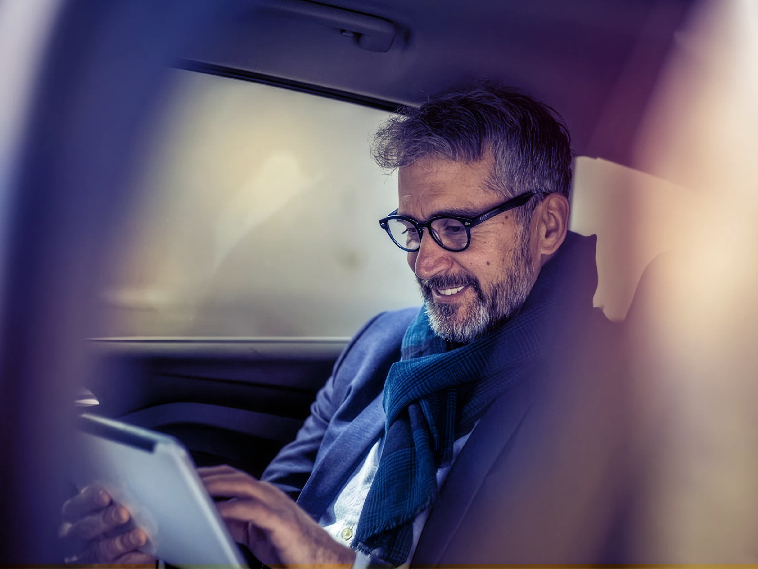 Man working on lead scoring in Salesforce on a laptop inside a vehicle