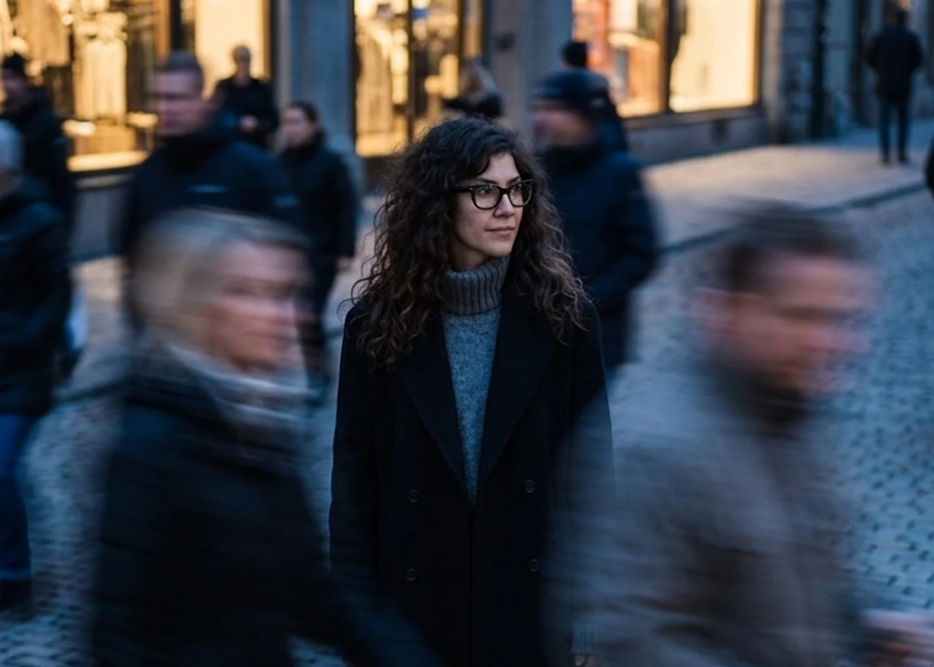 Jessica Del Grande, founder of Partial History, standing in a Paris street at dusk.