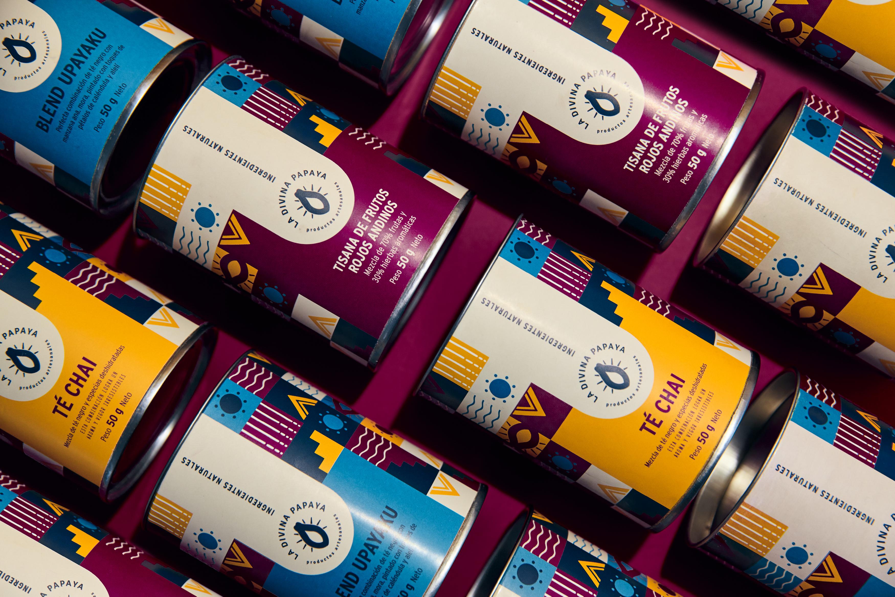 Editorial tea packaging photography for La Divina Papaya by Lunalunares, featuring multiple branded tins with colorful patterned labels arranged diagonally over a deep magenta background.