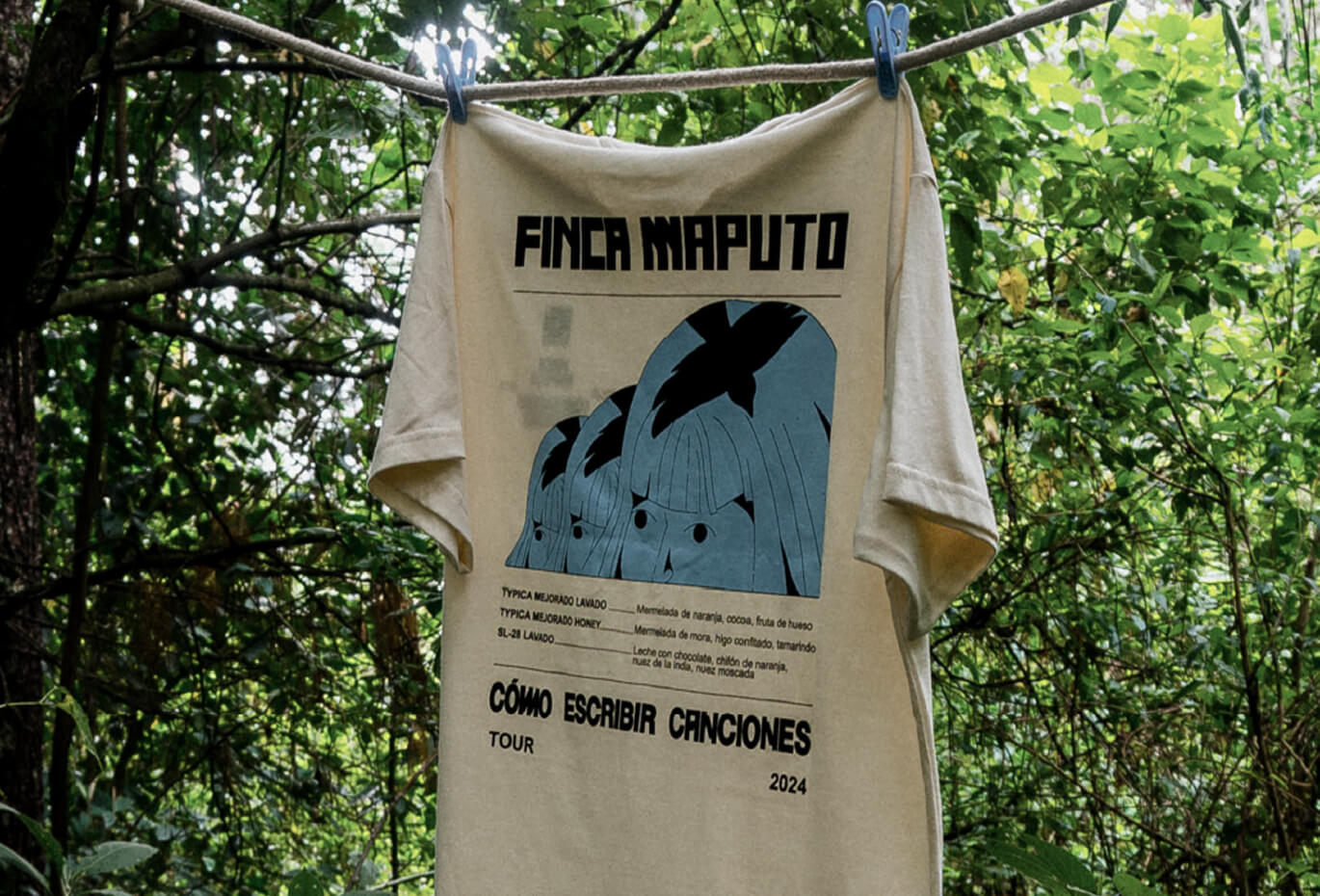Merchandise design for Finca Maputo featuring a printed T-shirt hanging in a lush natural setting, with bold typography, illustrated graphics, coffee tasting notes, and tour-inspired visual language created by Lunalunares Studio for a cultural and lifestyl