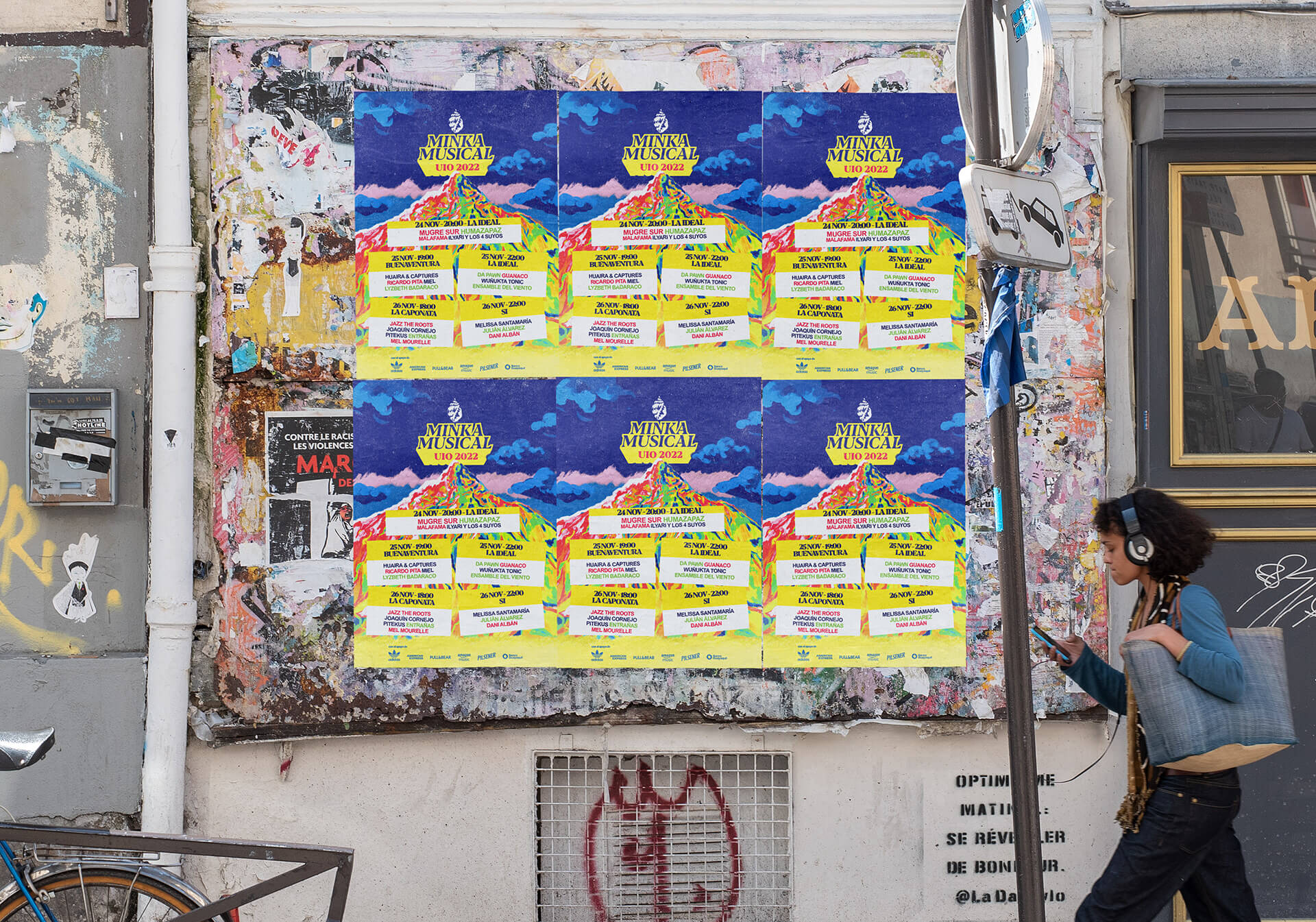Street poster campaign for Minka Musical by Lunalunares, showing repeated UIO 2022 event posters with colorful mountain artwork applied to an urban wall environment.