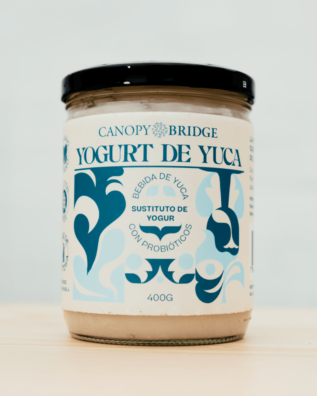 Yuca yogurt packaging for Canopy Bridge by Lunalunares, featuring a glass jar with botanical blue illustrations, probiotic product messaging, and a clean natural food brand identity.