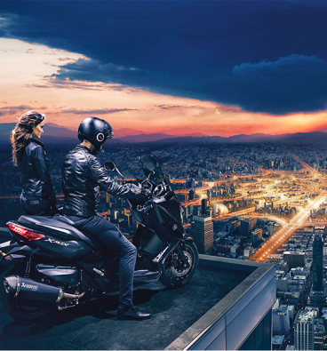 Riders with a Yamaha XMAX overlooking a city