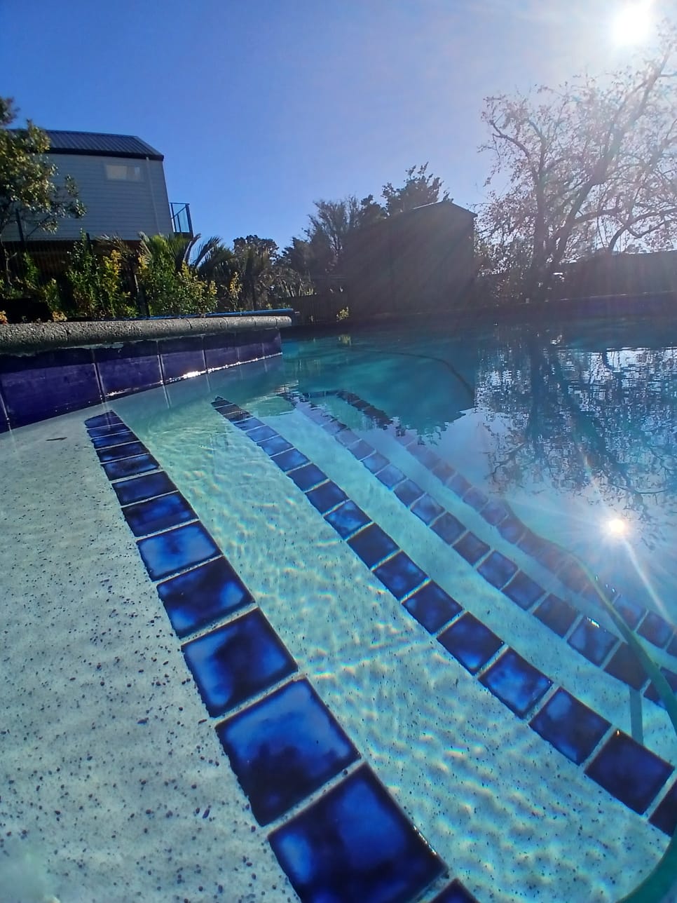 A tired, ageing plaster pool was completely resurfaced in NZ Pool Pebble Hauraki Blue, restoring the interior and giving the pool a fresh, clean finish designed for years of use