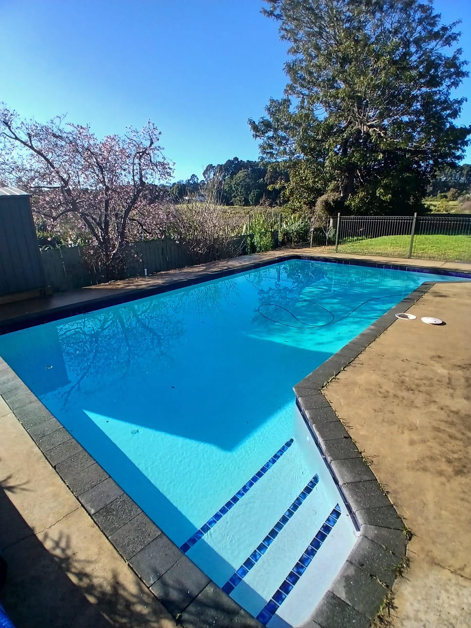 A tired, ageing plaster pool was completely resurfaced in NZ Pool Pebble Hauraki Blue, restoring the interior and giving the pool a fresh, clean finish designed for years of use