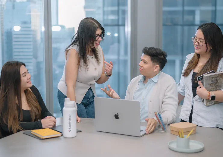 Two female professionals collaborating on a laptop, illustrating a tailored hiring approach