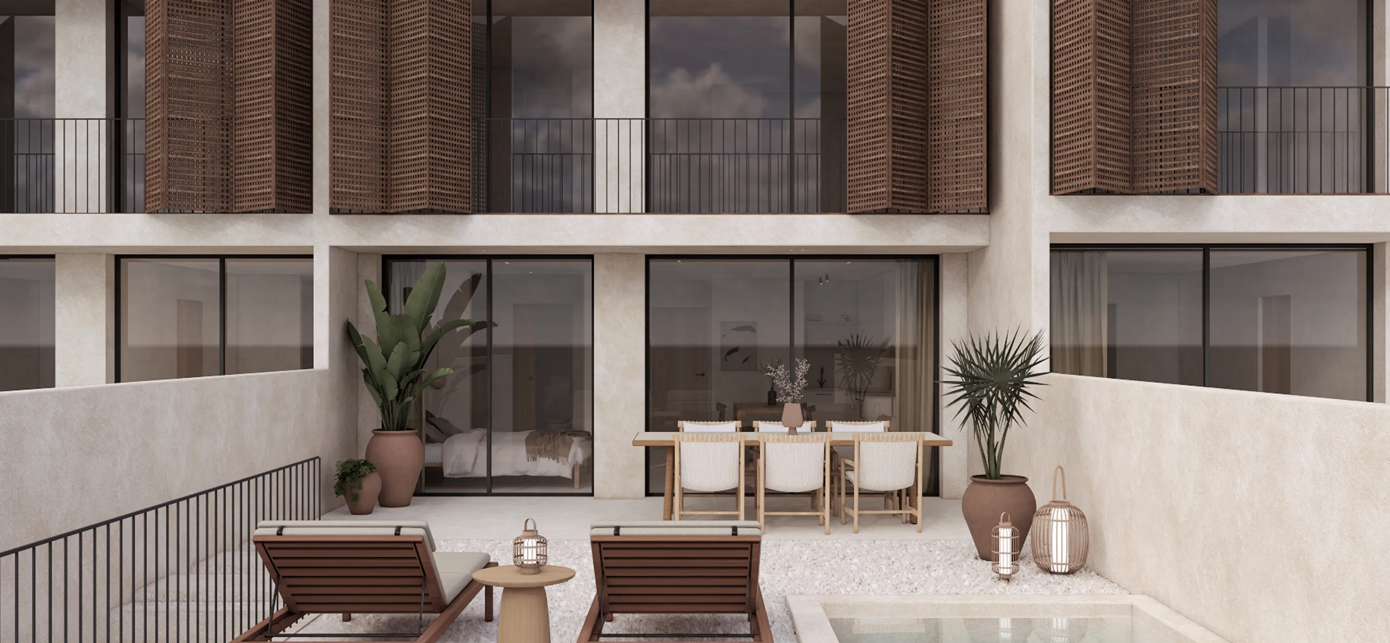 Luxury outdoor terrace design at Can Lantana in Ibiza, featuring wooden sun loungers, an outdoor dining setup, and bespoke architectural shutters.