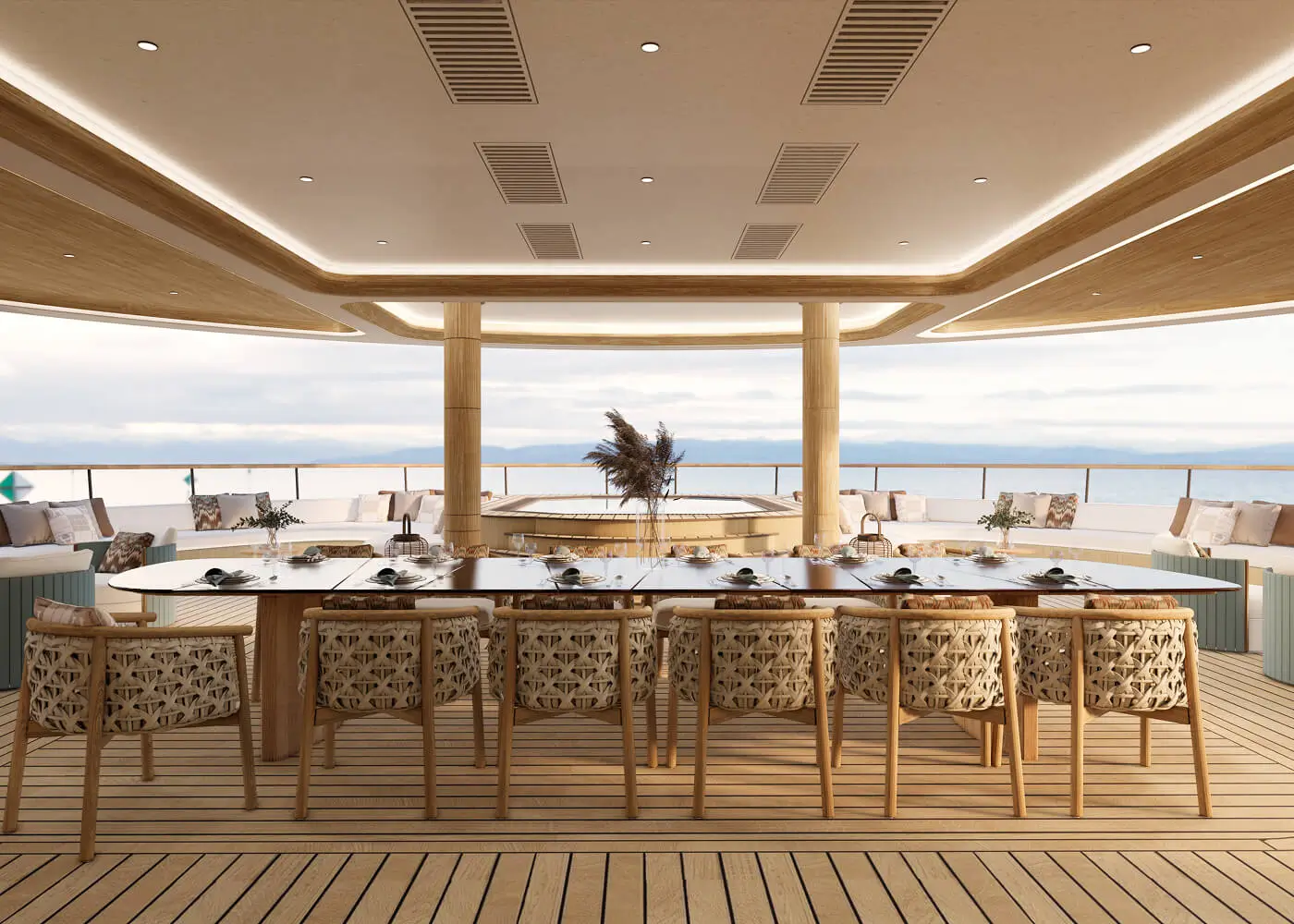 Luxury yacht upper deck dining and lounge space from the Bird of Paradise 75m yacht refit by Studio Moravová. Features a long custom timber dining table with woven chairs, curved built-in seating, a teak deck, and a raised jacuzzi under a natural timber ce
