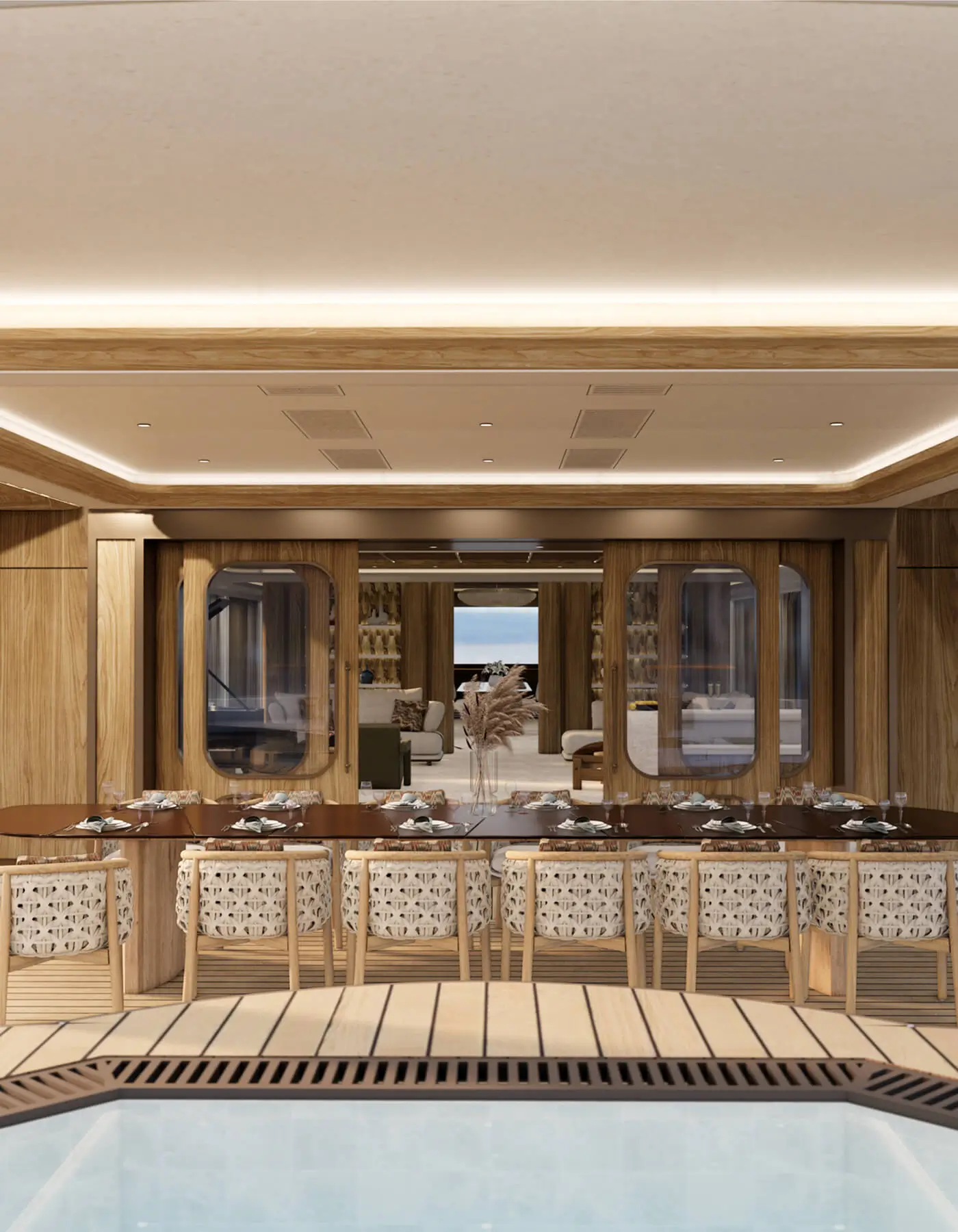 Teak outdoor deck of the Bird of Paradise 75m yacht looking towards custom glass sliding doors with rounded windows. Features a long wooden dining setup and a built-in jacuzzi edge, highlighting the seamless relationship between interior and exterior space