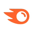 Orange comet-shaped symbol with a circular core on a black background.