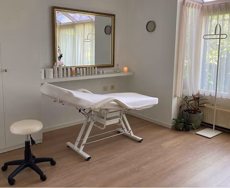 The interior of the Muse Maven Beauty Salon with a big mirror and a massage bed