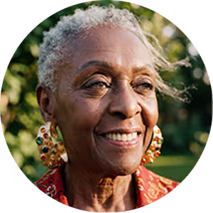 Smiling elderly woman with short gray hair and colorful earrings outdoors.