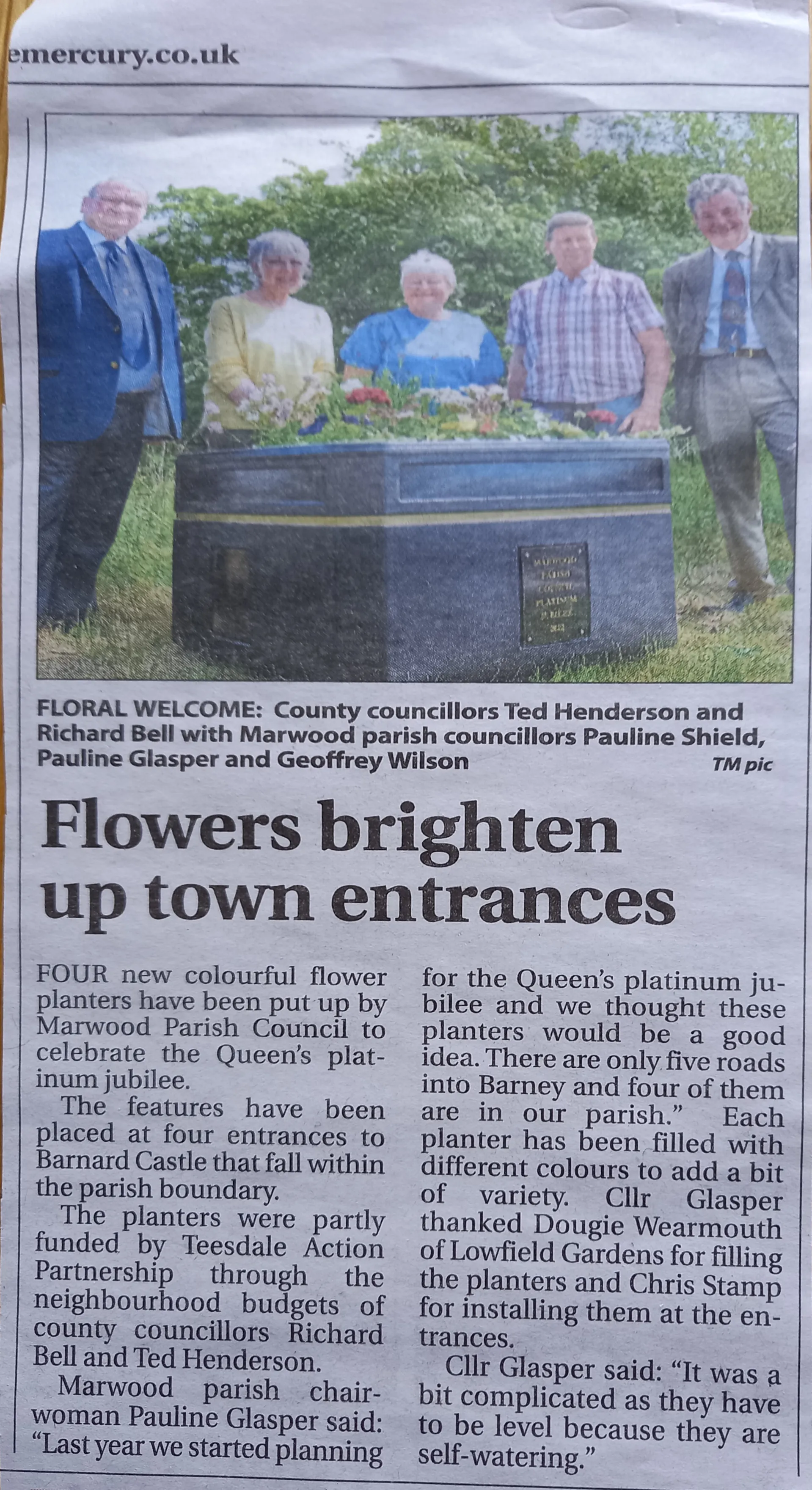 Newspaper clipping about flowers for town enterances