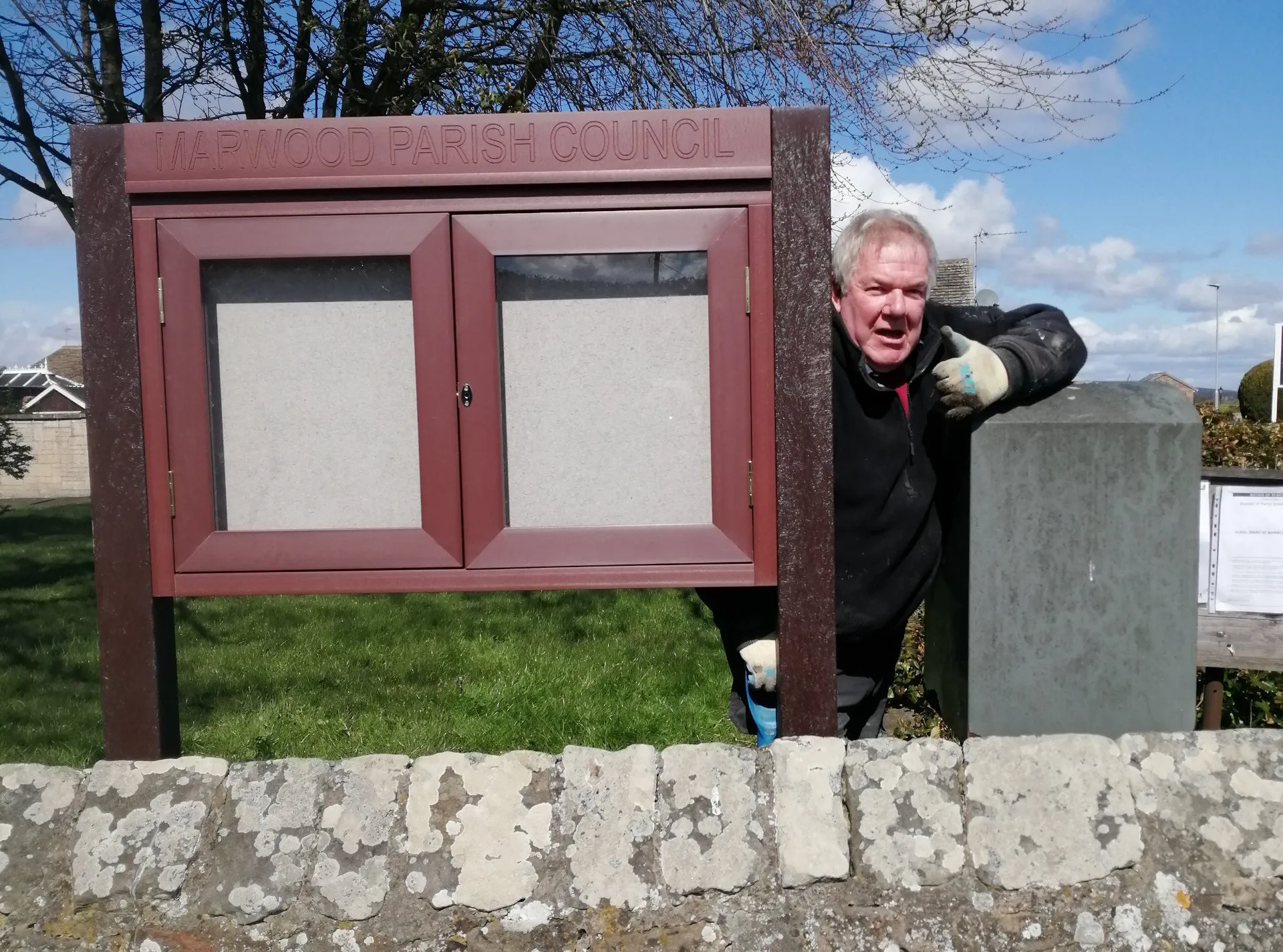 New village noticeboard being installed