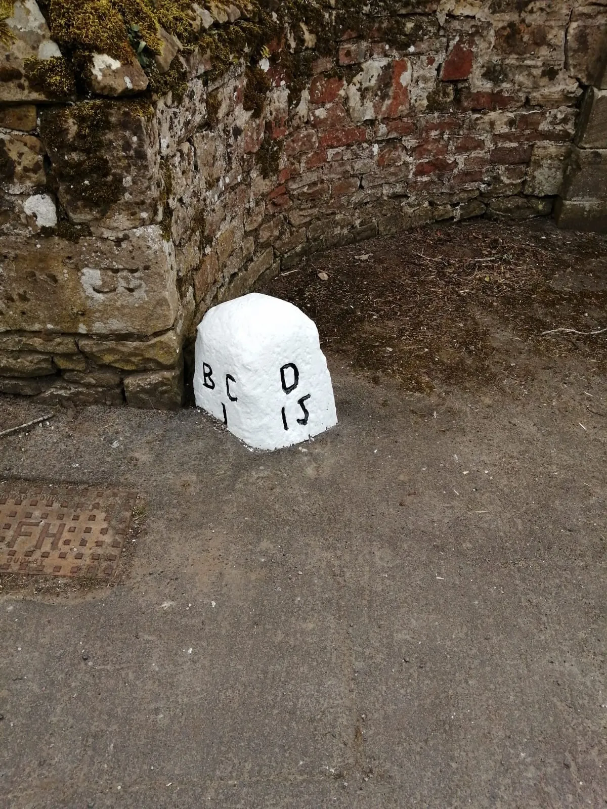 Milestone painted in white with black lettering