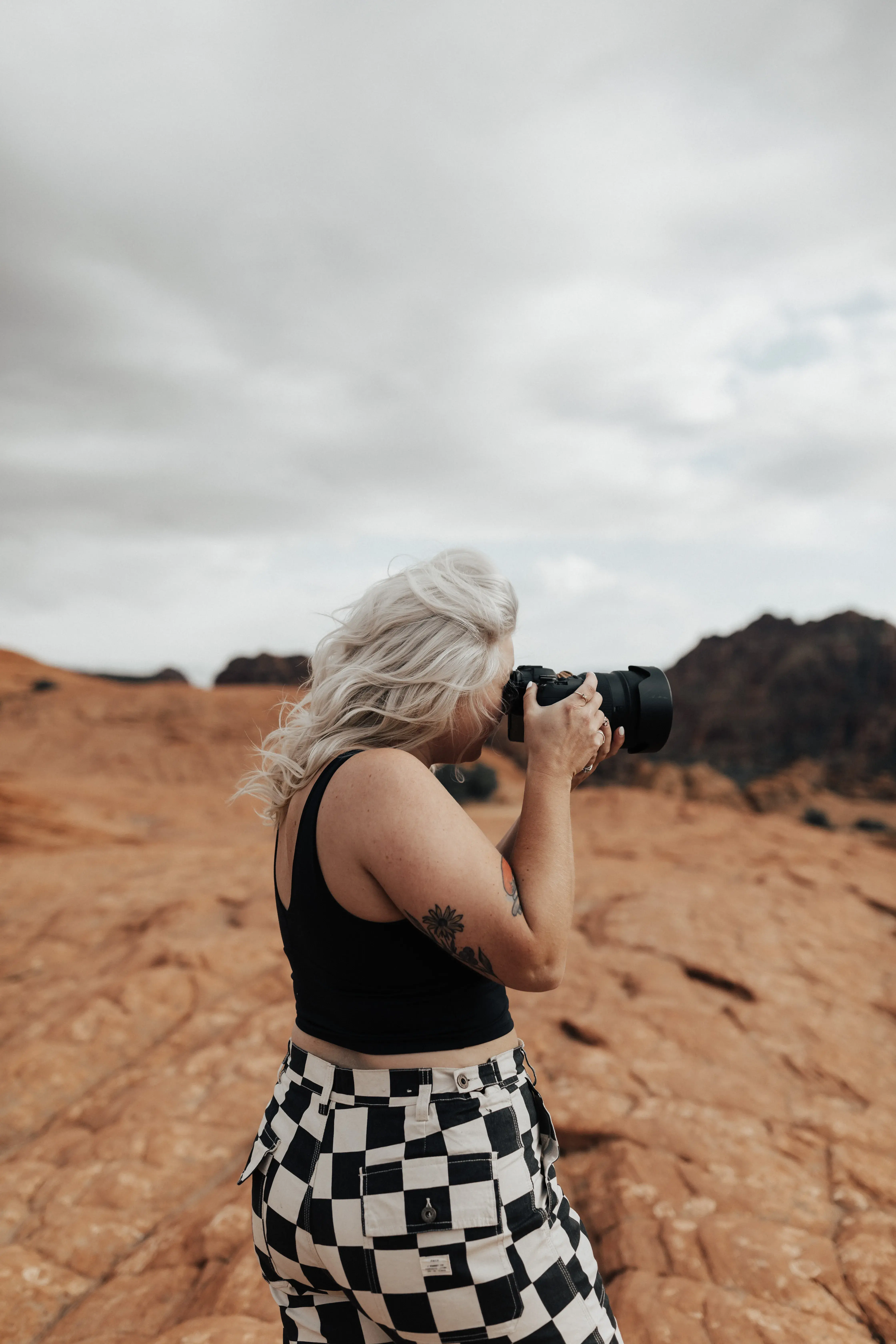 Massachusetts wedding and elopement photographer photographing a couple among dramatic red rock formations during an adventurous destination session.
