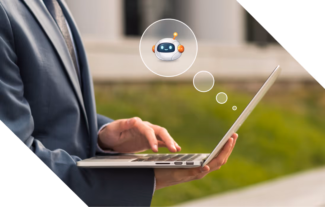 Business professional using a laptop with an AI chatbot icon floating above it.