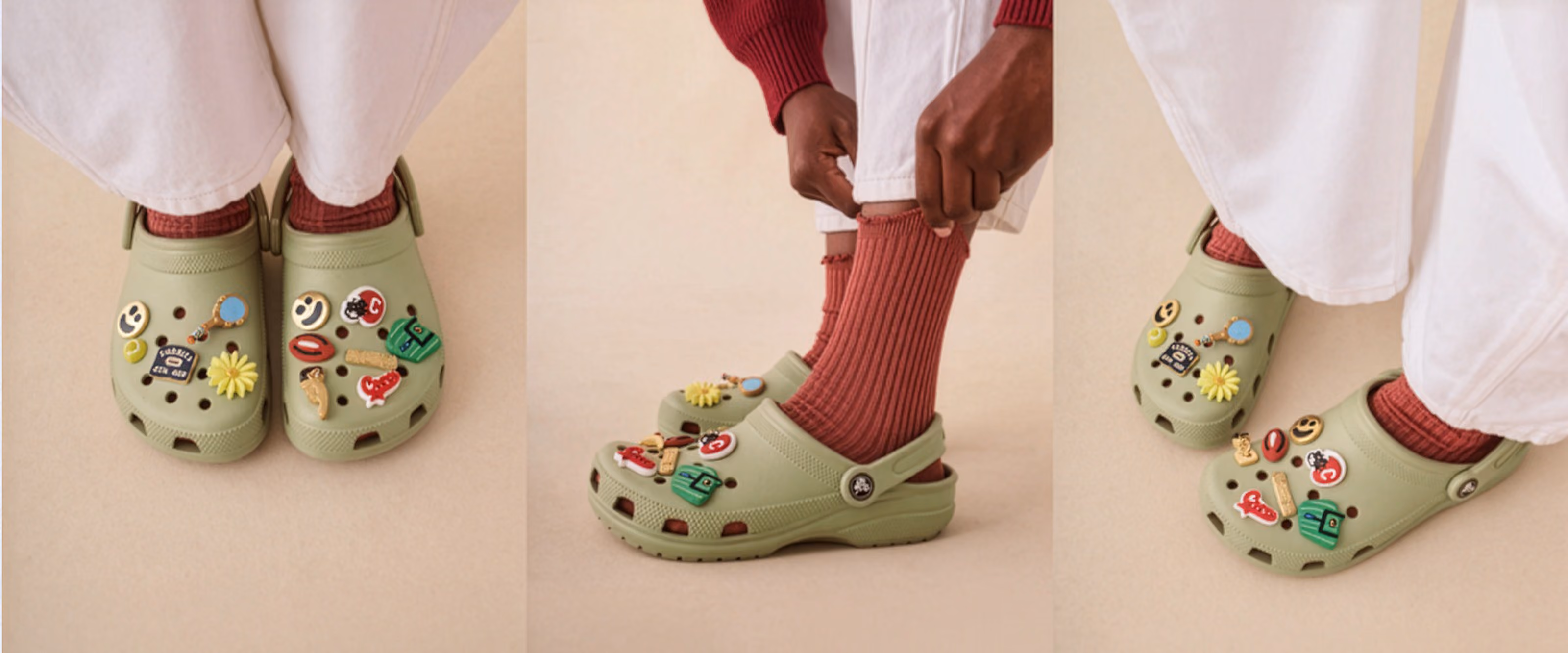 People wearing green Crocs clogs decorated with colorful Jibbitz charms.