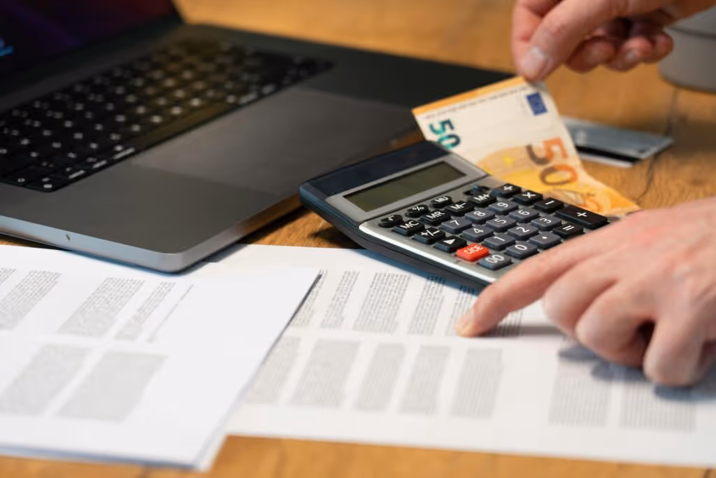 Man Hands over Documents and Calculator