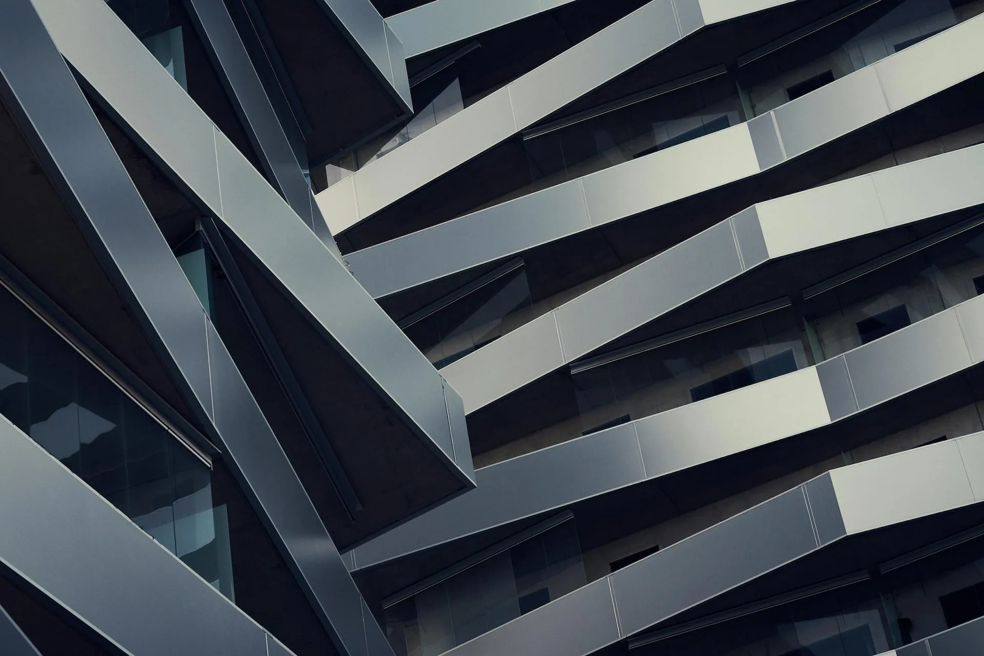 A close-up view of a modern building with a unique architectural design featuring staggered balconies.