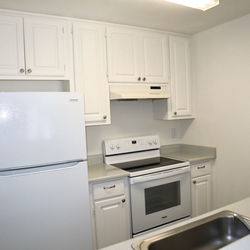 Kitchen with white cabinets and appliances