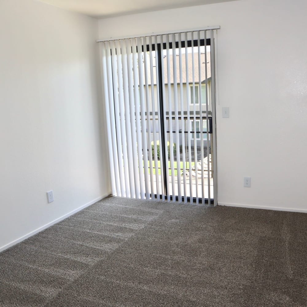 Unfurnished living area with patio balcony doors