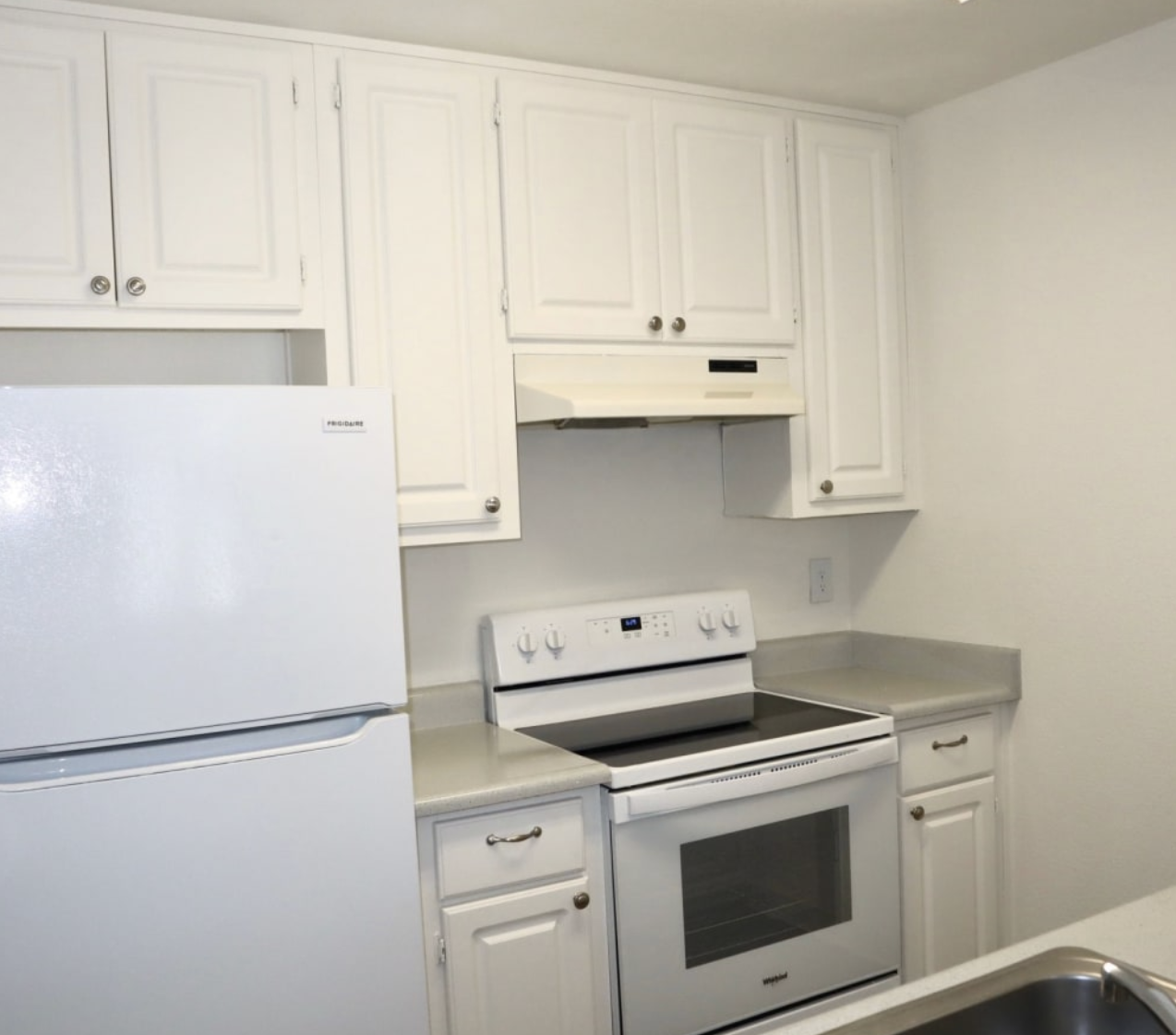 Kitchen with white cabinets and white appliances